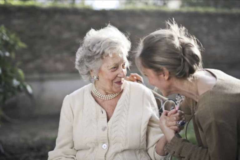 Two women smiling together outdoors